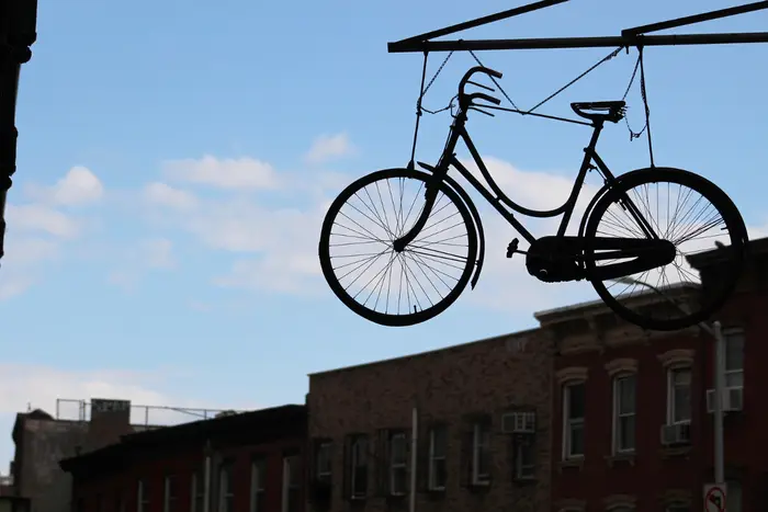A photo of a bike hanging on Hewes Street